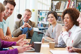 Photo of a group of librarians meeting in a library
