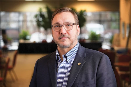 Man with glasses wearing a jacket