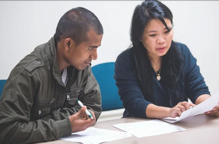 Two people discussing a paper